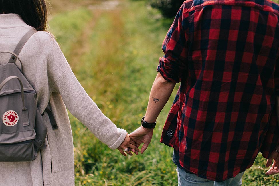 Tattoos and holding hands in this European wedding photography.