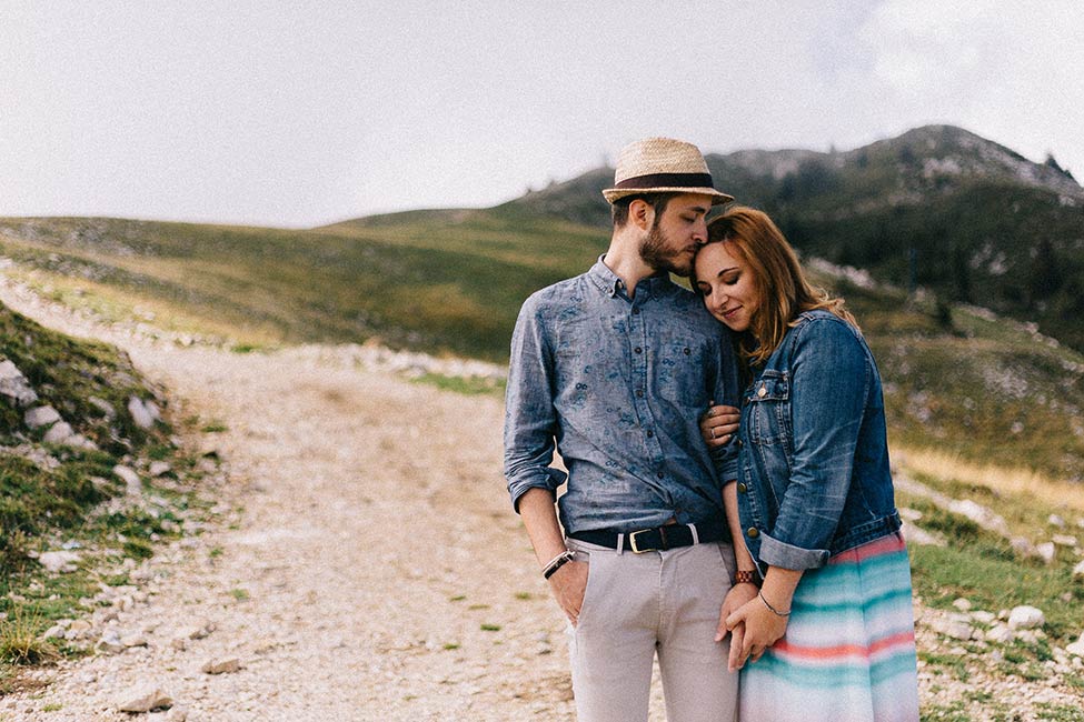 Enrico and Eleonora, an Italy photographer duo of Enrico e Eleonora Forografo, embrace while taking engagement photos in Verona, Italy.