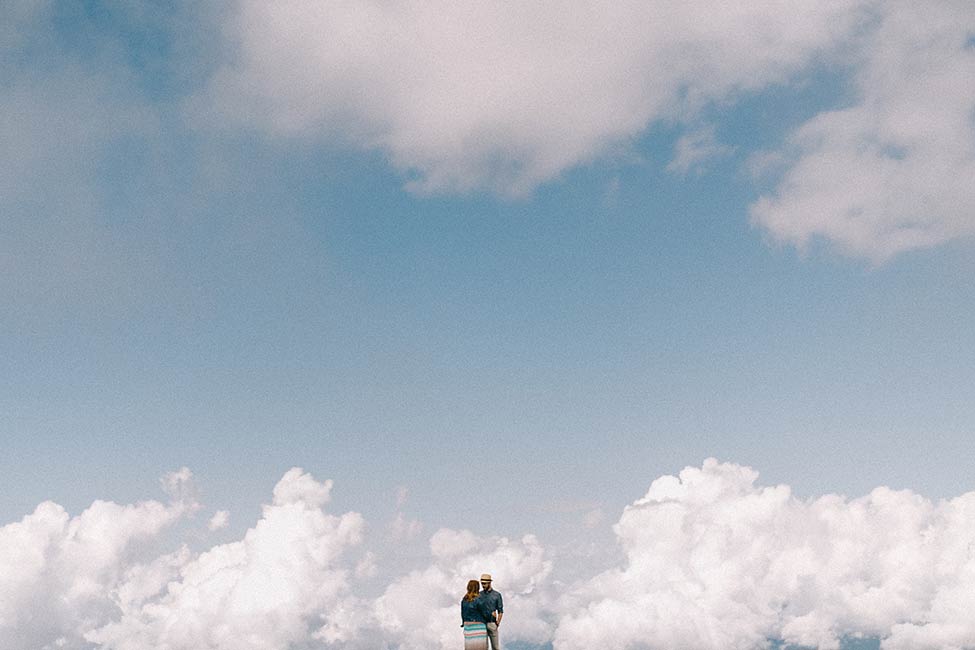 A couple in the clouds on their engagement session for a lago di garda wedding in italy.