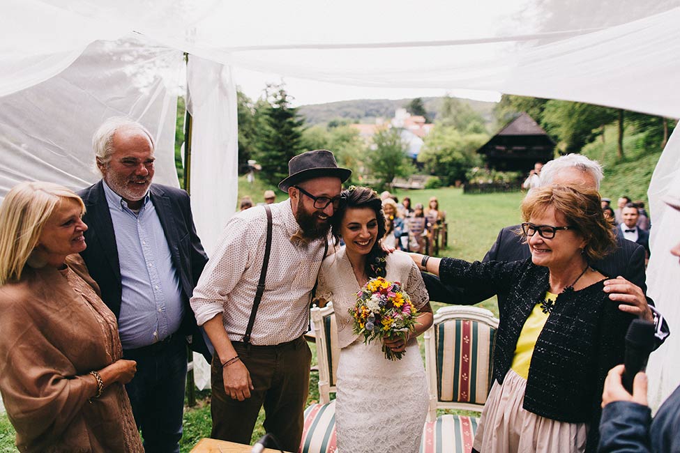 The new family embraces on this magical Austrian wedding high in the Alps. A wedding is a celebration of a growing family.