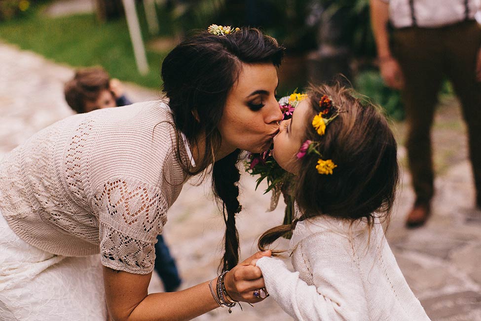 Mother and daughter share a kiss as their family grows in number and love.